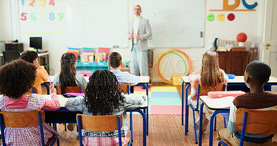 Buy stock photo Lesson, education and teacher with children in classroom for learning, knowledge or teaching. Whiteboard, male person and educator with kid students for growth and development at elementary school.