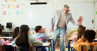 Buy stock photo Teacher, child and high five for learning in classroom with smile, support or education at school. Mature man, kids and celebration with goals, quiz and happy for success with achievement at academy