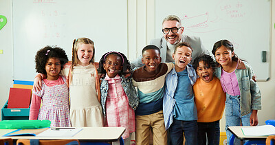 Buy stock photo Education, hug and portrait of students with teacher in classroom for development or growth. Learning, smile or study with educator man and excited group of kids in class of elementary school
