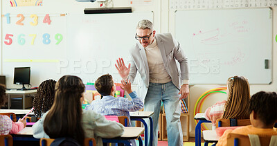 Buy stock photo Teacher, boy and high five for learning in classroom with smile, support and education at school. Mature man, kids and celebration with goals, quiz or happy with motivation for achievement at academy