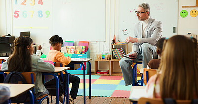 Buy stock photo Tablet, classroom and teacher with children for learning, education or development with storytelling. Teaching, digital technology and male educator with students in elementary school for growth.