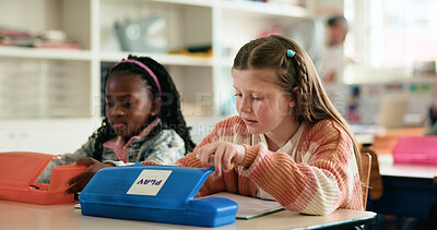 Buy stock photo Stationery, box or girls in classroom for learning education, test paper or solution with students. Creative, quiz or smart kids at school for child development, assessment or knowledge evaluation