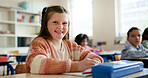 Happy, writing and portrait of child in classroom with confidence for education, learning or growth. Smile, student and face of girl kid at elementary school for quiz, test or assessment at campus.