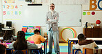 Crossed arms, man and portrait of teacher in classroom with confidence for education career. Students, happy and male educator with children for lesson with learning or knowledge at elementary school