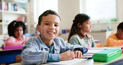 Buy stock photo Smile, writing and portrait of child in classroom with confidence for education, learning or growth. Happy, student and face of boy kid at elementary school for quiz, test or assessment at campus.