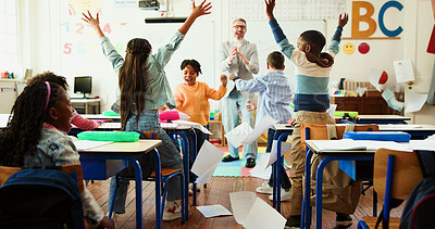 Buy stock photo Applause, celebration and education with teacher and kids in classroom for quiz pass, success and lesson. Exam achievement, learning and test grade with students and man in school for scholarship