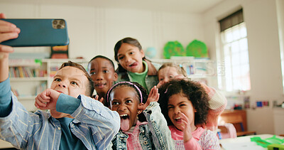 Buy stock photo Education, funny face and selfie with children in class together for learning or memories. Development, growth and profile picture with group of excited kids in school classroom for social media