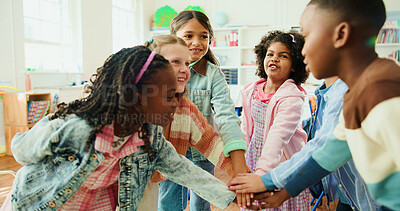 Buy stock photo Education, huddle and motivation with children in class of elementary school for success or support. Hand stack, learning and study with group of kids in classroom for achievement as friends