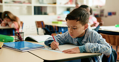 Buy stock photo Education, students and kid writing in classroom for learning, math or problem solving. Development, boy and assessment at school for numeracy knowledge, academic assignment or test evaluation