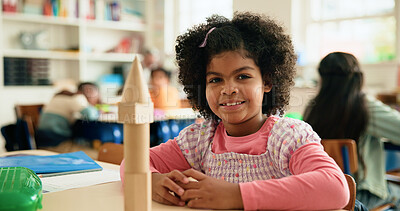 Buy stock photo Building blocks, learning and portrait of student girl at desk in classroom of elementary school. Education, smile and study with happy child in class for coordination or motor skills development