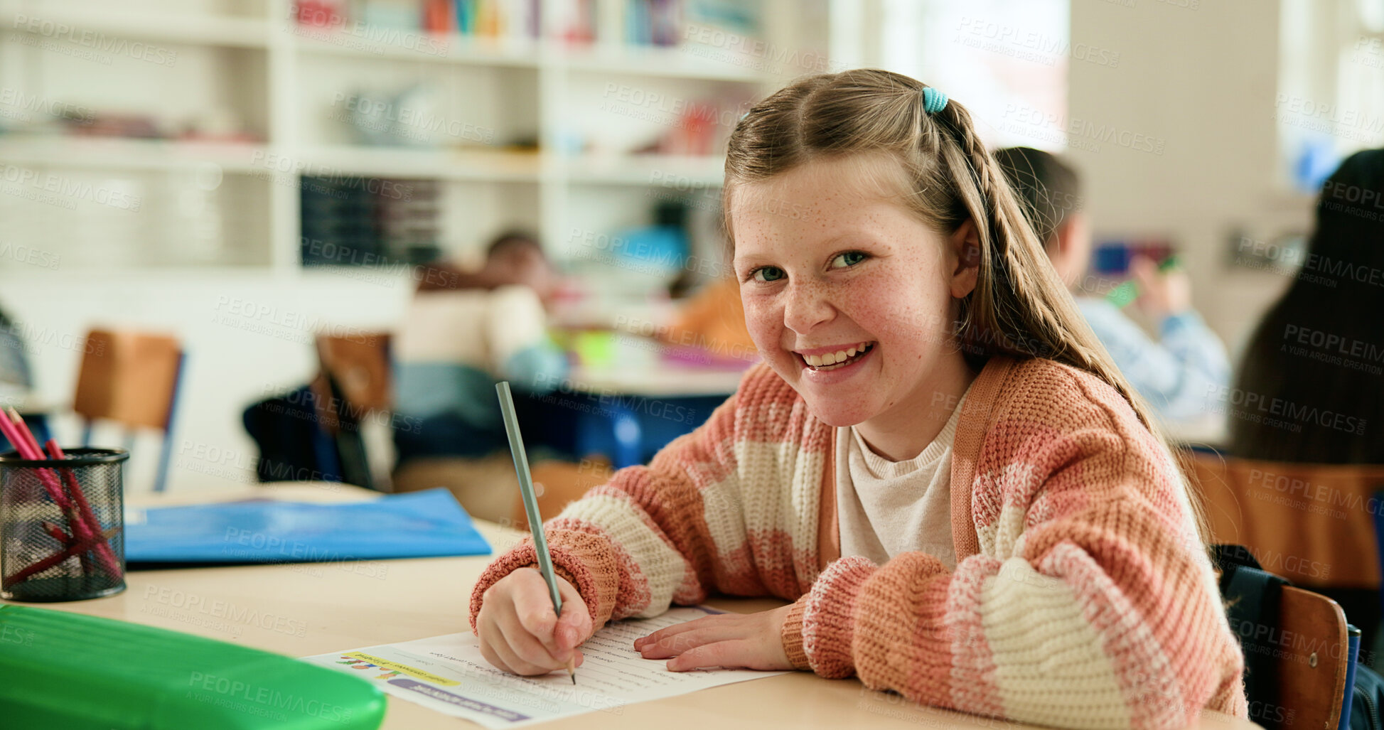 Buy stock photo Girl, child and portrait in classroom with writing test, smile or confident with assessment at academy. Kid, paper and happy for answer with language, learning and education at elementary school