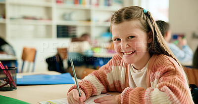 Buy stock photo Girl, smile and portrait in classroom with writing test, pride or confident with assessment at academy. Child, paper and happy for answer with language, learning and education at elementary school
