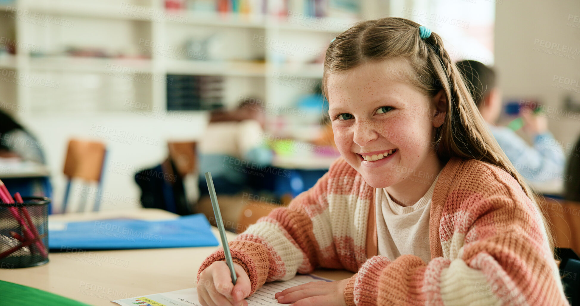 Buy stock photo Girl, smile and portrait in classroom with writing test, pride or confident with assessment at academy. Child, paper and happy for answer with language, learning and education at elementary school