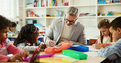 Buy stock photo Education, learning or writing with students and teacher at desk in classroom for child development. Future, growth or notes with educator man teaching kids in elementary school class for lesson