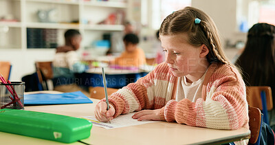 Buy stock photo Girl, education and writing test in classroom with problem solving, development or assessment at academy. Child, paper and solution for question with language, learning and quiz at elementary school