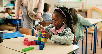 Buy stock photo Girl, education and building with blocks in classroom, learning and puzzle for problem solving with games. Child, wood toys and development with shapes, solution and thinking at elementary school