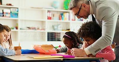 Buy stock photo Education, teacher and man with children, writing or helping students with assignment or elementary. Knowledge, growth and development of kids in classroom, educator and teaching learner in school