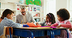 Classroom, teacher and man with children, writing or helping students with assignment and education. Learning, kids and educator with curriculum for knowledge, growth and development in elementary