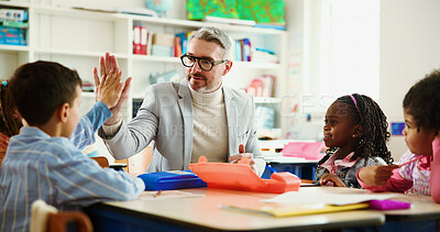 Buy stock photo Teacher, child and high five for motivation in classroom with smile, support and education at school. Mature man, kids and celebration with goal, quiz or happy for success with achievement at academy