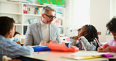 Buy stock photo Learning, discussion and teacher with kids in classroom for advice, assessment help and support. Education, teaching and knowledge with group of students and man in school for child development