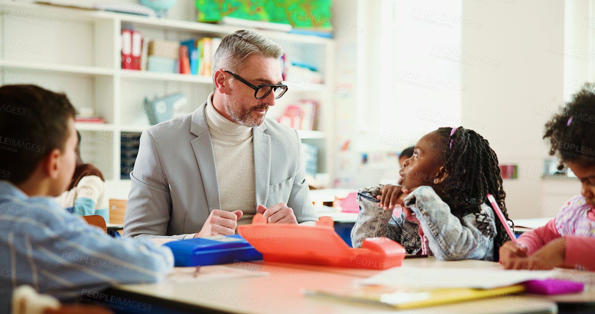 Buy stock photo Learning, discussion and teacher with kids in classroom for advice, assessment help and support. Education, teaching and knowledge with group of students and man in school for child development