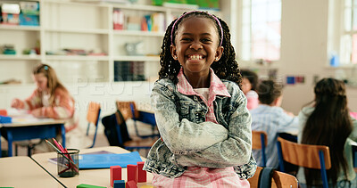 Buy stock photo Girl, child and portrait in classroom with arms crossed, smile and confidence for learning at academy. Kid, happy learner and pupil for education, ready or development with pride at elementary school