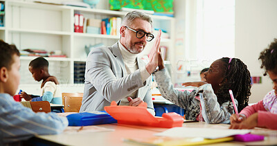 Buy stock photo Teacher, girl and high five for motivation in classroom with lesson, support and education at academy. Mature man, kids and celebration with goal, quiz or happy for success with achievement at school
