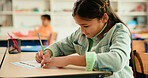 Education, students and girl writing in classroom for learning, mental math or problem solving. Development, kid or assessment at school for numeracy knowledge, academic assignment or test evaluation