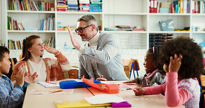 Buy stock photo Teacher, girl and high five for learning in classroom with lesson, motivation or education at academy. Mature man, kids and celebration for goal, quiz and happy for success with achievement at school