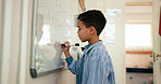 Whiteboard, education and student in classroom for learning math, problem solving or knowledge. Elementary school, student and boy kid writing for growth, development or presentation at academy.