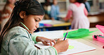 Girl, drawing and book for education in classroom, development or art for assessment at academy. Child, paper and thinking with color, learning and creativity for sketching at elementary school