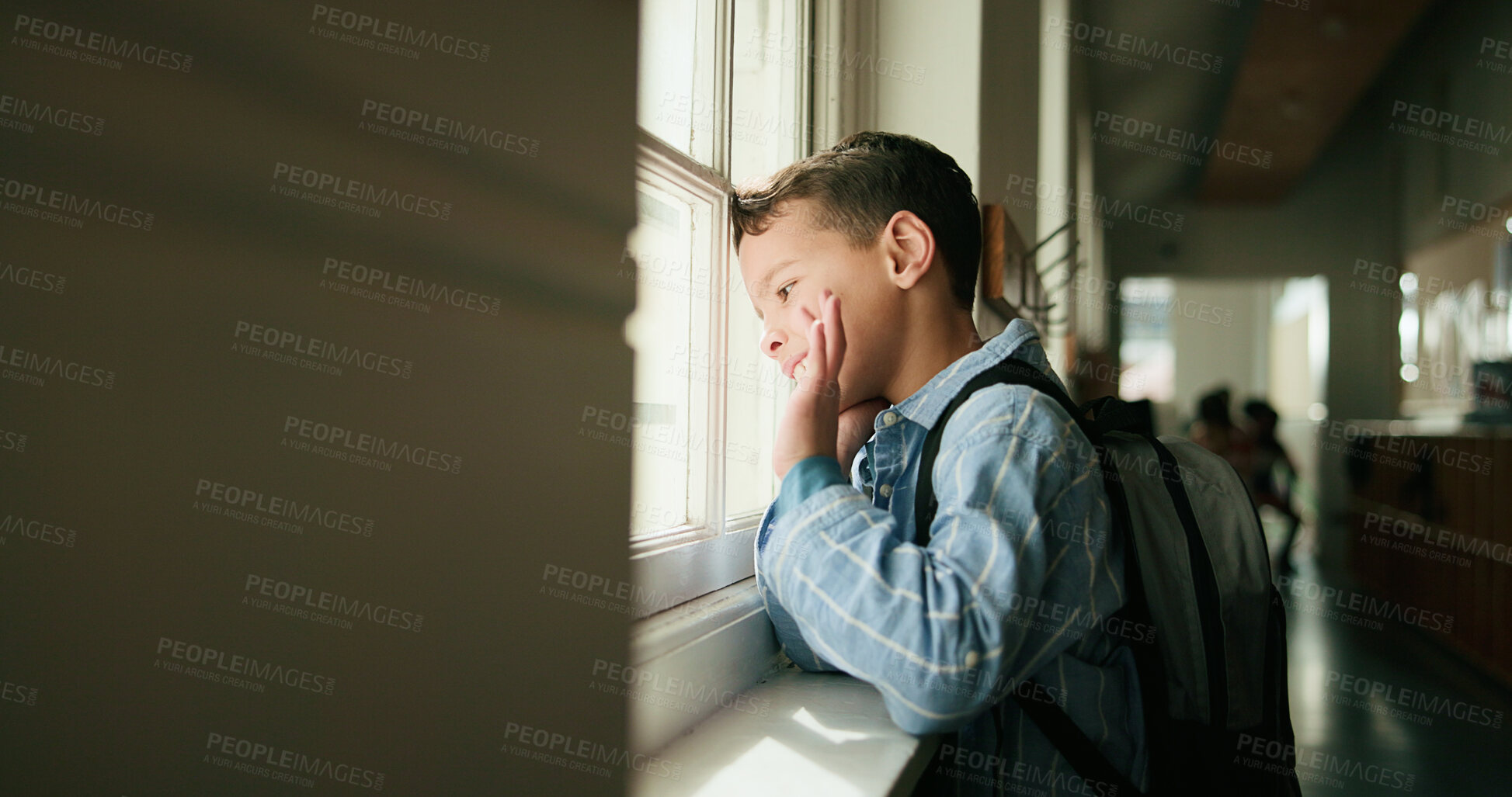 Buy stock photo Boy, happy and wave at window, school and ready for learning, development or thinking in corridor. Child, smile and greeting with gesture, backpack and goodbye in hallway for education at academy