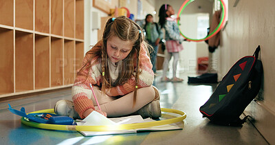Buy stock photo Girl, child and writing with notebook in hallway for studying, knowledge and education for future. Kid, student and development for scholarship with assignment, learning or assessment in plastic hoop