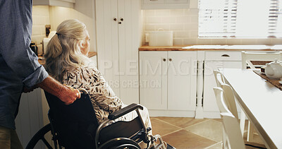 Buy stock photo Kitchen, tea and wheelchair with senior couple in home together for bonding, retirement or wellness. Assistance, help and old man pushing woman with disability in apartment for start of morning