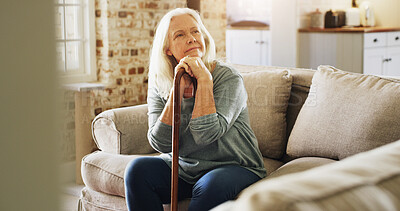 Buy stock photo Thinking, walking stick and senior woman in home with relax, peace and medical support. Memory, mobility aid and elderly female person with disability, parkinson or arthritis on sofa in house.