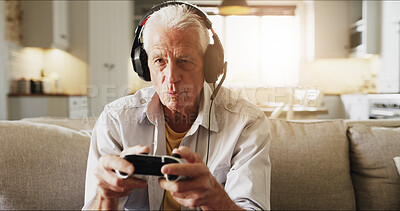 Buy stock photo Elderly man, console and playing video games with headphones on sofa for online entertainment. Retirement fun, senior gamer or male person with controller or headset for arcade competition in house
