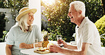 Senior, happy couple or laughing with breakfast in garden for healthy snack, water or pineapple. Elderly, man and woman with smile, funny joke or humor for comedy, retirement or natural organic fruit