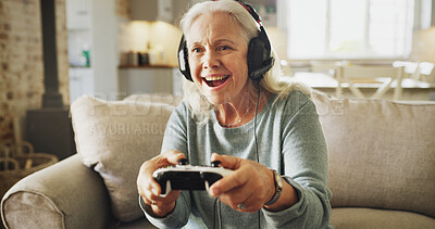 Buy stock photo Senior, happy woman and playing with video games on sofa for fun online entertainment in home. Excited, elderly gamer or female person with smile, control or headphones for console gaming in house