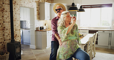 Buy stock photo Fun, dance and senior couple with costume, happy marriage and retirement wellness in home. Music, bonding and old people in kitchen together with love, energy and halloween dress up on weekend