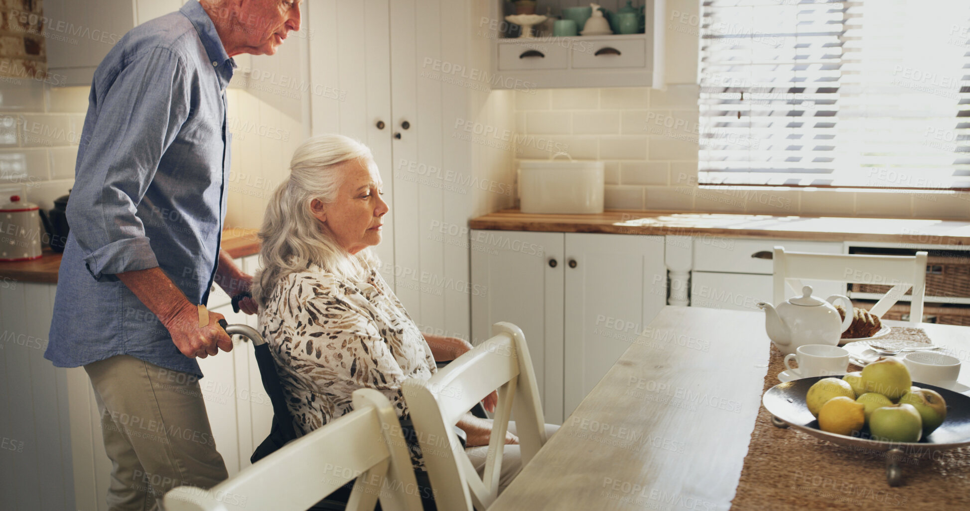 Buy stock photo Breakfast, tea and wheelchair with old couple in kitchen of home together for retirement or wellness. Hunger, food and senior man pushing woman with disability in apartment for start of morning