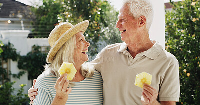 Buy stock photo Outdoor, bonding and senior couple with fruit, patio or laughing on break, wellness or healthy diet. Home, old woman and elderly man with pineapple on weekend, romance or people with humor for joke
