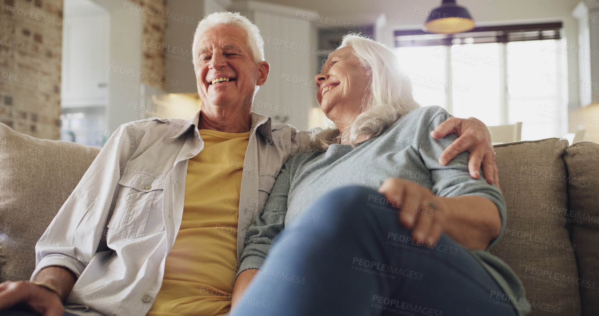 Buy stock photo Hug, laughing and relax with old couple on sofa in living room of home together from below. Funny, love and retirement with happy senior people in apartment for bonding, conversation or wellness