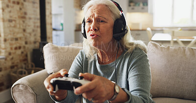 Buy stock photo Senior woman, console and playing video games with headphones on sofa for online entertainment. Pensioner, elderly gamer or female person with controller or headset for online competition in house