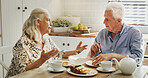 Cake, conversation and senior couple in home with bonding together for dessert with tea. Talking, relax and elderly man with woman in retirement for eating sweet treat with coffee in kitchen in house