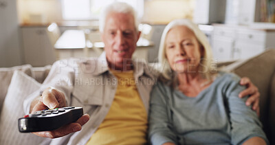 Buy stock photo Senior couple, relax or watching TV with remote on sofa for online entertainment or channel in home. Elderly, man and woman with controller for movie subscription, bonding or retirement show in house