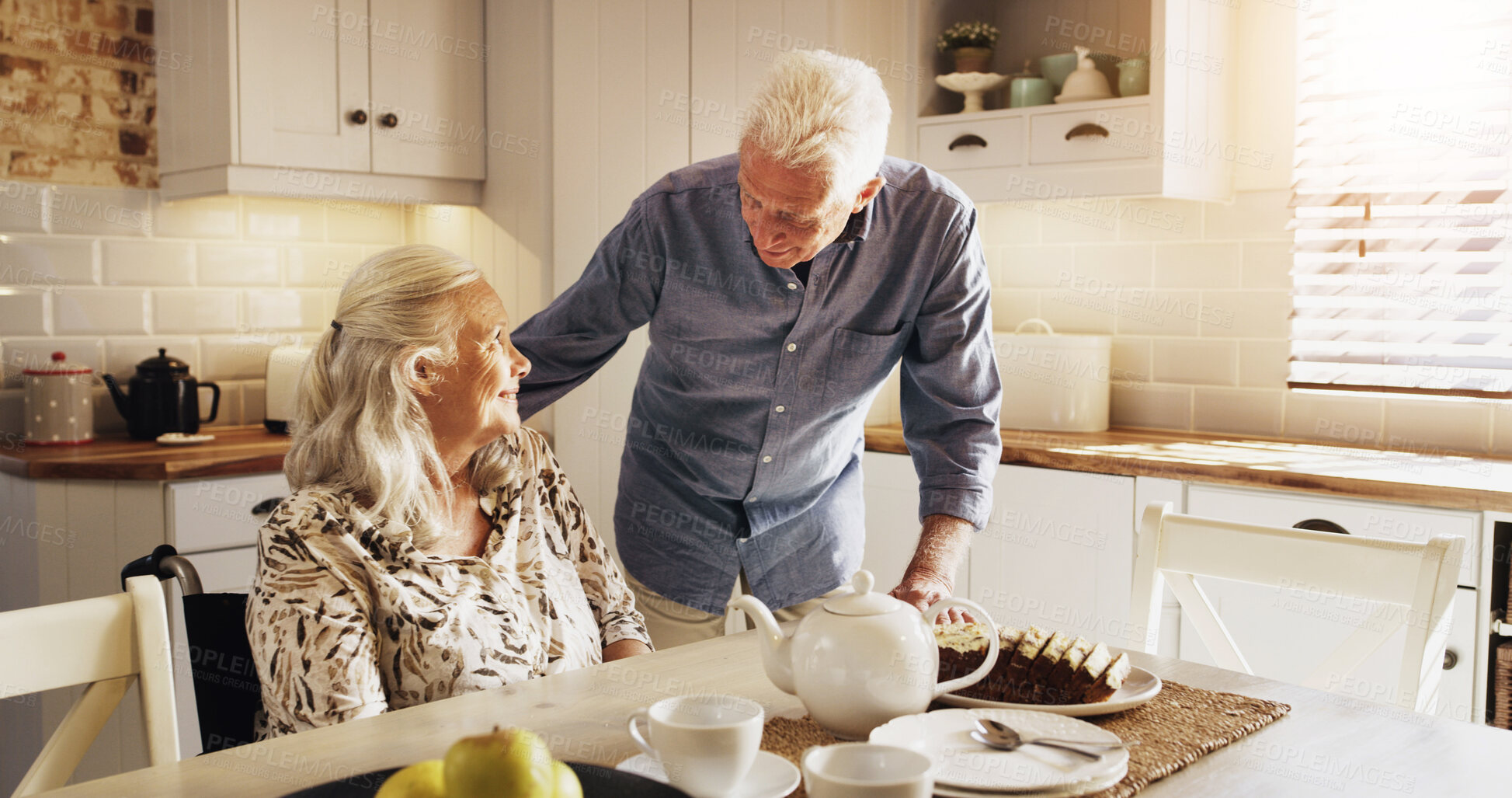 Buy stock photo Talking, tea and wheelchair with old couple in kitchen of home together for retirement or wellness. Cake, hunger and senior man speaking to woman with disability in apartment for start of morning