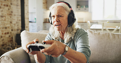 Buy stock photo Senior, angry woman and playing with video games on sofa for competitive action or esport in home. Elderly, female person or gamer with anger, controller or headphones for online competition in house