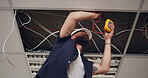 Electrician, man and meter with light wires for construction, remodeling project or renovation. Handyman, contractor repair and maintenance for electric fixture, circuit or installation for office