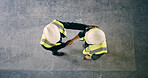 Top view, engineer and people with handshake for construction deal, agreement or space. Above, architect and team shaking hands for collaboration, building development and safety approval at site