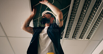 Buy stock photo Electricity, repair or man with cable in roof, light installation or maintenance check for safety. Below, electrician or person with wire for led fixture, power inspection or connection in ceiling.